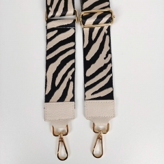 Taschengurt Taschenriemen Zebra Muster, schwarz cremewei mit cremeweien Lederenden, goldfarbige Schnalle