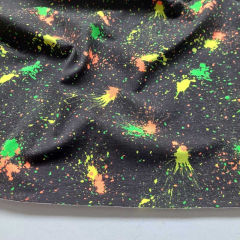 Jerseystoff Farbkleckse Neonfarben, schwarz